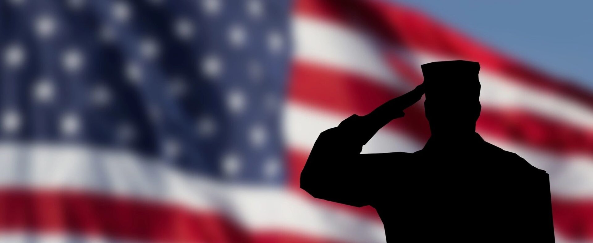 A soldier saluting in front of an american flag.